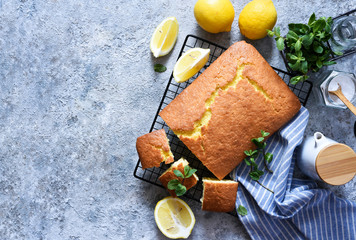 Lemon cake with zest on a concrete background. View from above.