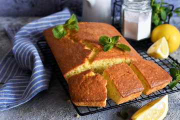 Lemon cake with zest on a concrete background. View from above.