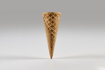 Empty medium wafer cone for ice cream isolated on white. Concept of food, treats. Mockup, template for your advertising and design. Close up