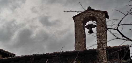 bell tower, bell against the backdrop of a cloudy sky