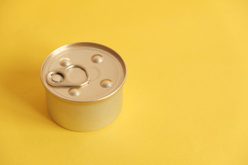 Canned food closed on yellow background. Top view. Copy, empty space for text
