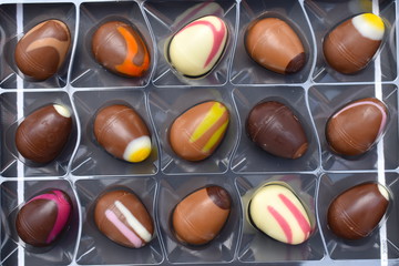 Hollow milk chocolate eggs consist of thick shell containing sweet filling including salted caramel pistachio macadamia simnel cake strawberry raspberry vanilla. Modern Christian customs on Easter day