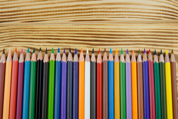 Fototapeta premium multicolored pencils on a colored background