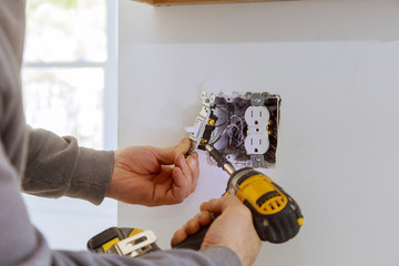 Work on installing electrical outlets. - obrazy, fototapety, plakaty