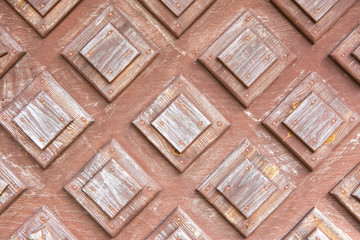 Naklejka premium Texture of the old wooden door with decorative elements