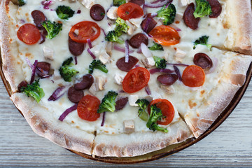 pizza with salami and tomatoes