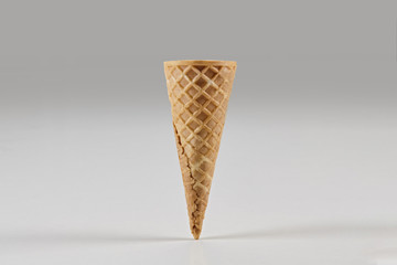 Empty wafer cone for ice cream isolated on white. Concept of food, treats. Mockup, template for your advertising and design. Close up