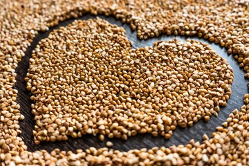 close shot of heart made of brown buckwheat pictured from the right side