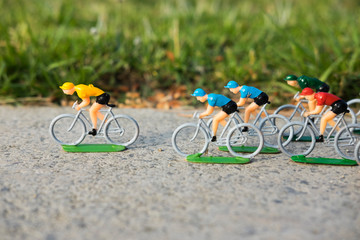 Plastic cyclist, yellow jersey cyclist winning the race.