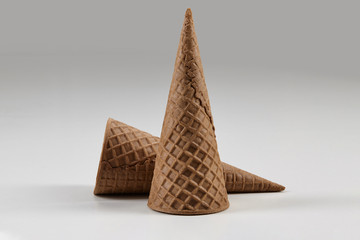 Two empty, big, chocolate wafer cones for ice cream isolated on white. Concept of food, treats. Mockup, template for advertising and design. Close up