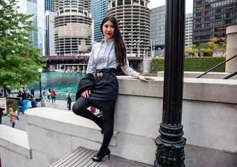 Beautiful Chinese Asian woman in fashionable business attire is enjoying a nice day walking around...