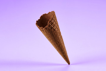 Empty, sweet, chocolate wafer cone for ice cream isolated on white. Concept of food, treats....