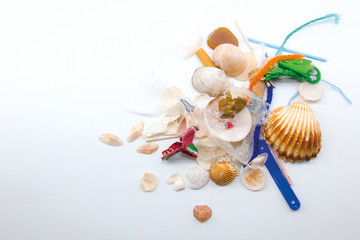 Sea shells mixed with plastic waste. Climate change and ocean pollution concept.
