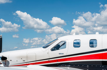 Fototapeta na wymiar Airplane exterior side-view. Plane against a blue sky