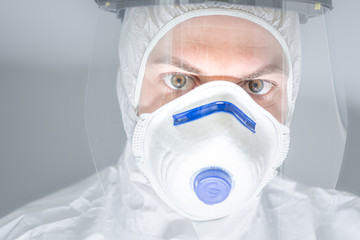 Portrait of man doctor in protective clothes during coronavirus pandemic. Epidemic, pandemic of coronavirus COVID 19