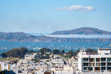 Obraz premium Blue Angel jet stalling at angle flying over San Francisco Bay, CA, USA, Aerial show, October 6, 2018