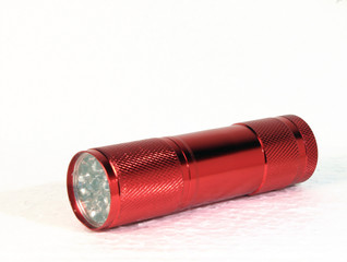 Red flashlight isolated on white background