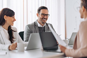 Fototapeta premium Portrait of cheerful elegant businessman smiling at the meeting