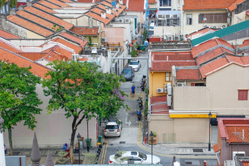 Singapore state and city street with colorful shops, skyscrapers, shops and tourists and locales. Singapore street life and architecture.