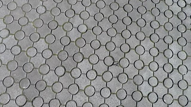 texture background paving tile made of gray concrete, round shape, camera movement in circles and down