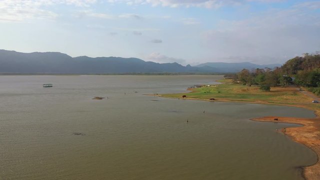February 29th, 2020 - Perlis, Malaysia : 4k Establishing Aerial View Timah Tasoh Lake side During Beautiful Sunset with Mountain view. Drone Rising Forward