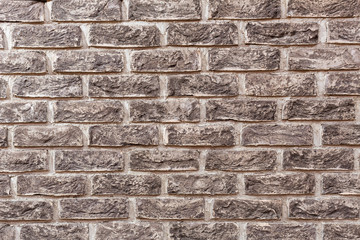 Handmade bricks on a white background. A rock. Construction. The wall is made of bricks.