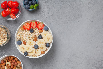 Healthy Breakfast oatmeal with fruit, berries and nuts.