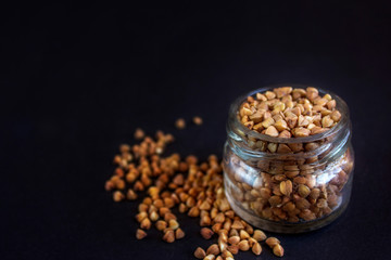 groats, buckwheat on a black background