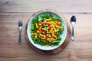 Fresh bright fitness salad and spoon on table 