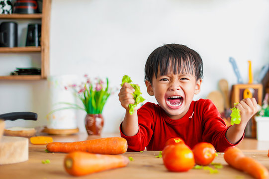 The boy was angry and showed displeasure in the kitchen.