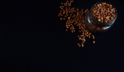 groats, buckwheat on a dark background
