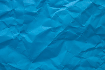 Obraz premium Blue crumpled paper texture as background. Copy space text