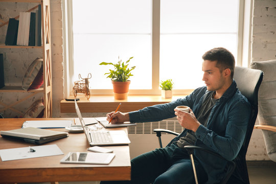 Creative Workplace - Organized Work Space As You Like For Inspiration. Man Working In Office In Comfortable Attire, Relaxed Position And Messy Table. Choose Atmosphere You Want - Ideal Clear Or Chaos.