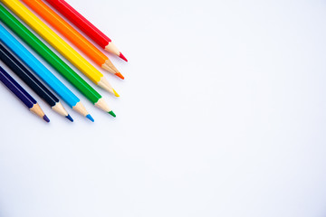 set of colored pencils on a white background with space for text