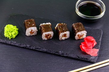 Sushi maki rolls with tuna on black slate