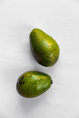 Avocado on white background, vegetarian food, mexican food, tropical fruit for breakfast, copy space. 