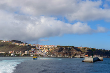 Fototapeta na wymiar Magnificent Views From The Sea With The Wake Of The Ferry And As Background The Island Of La Gomera. April 15, 2019. La Gomera, Santa Cruz de Tenerife Spain Africa. Travel Tourism Photography Nature.