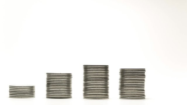 Silver coins on stacks are increase and decrease on white background stop motion animation