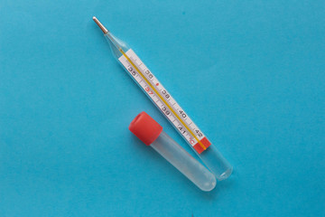 thermometer and test tube on a blue background
