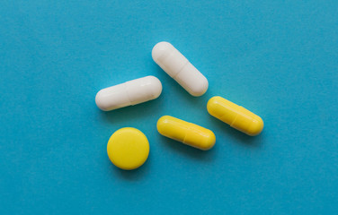 pills and capsules on a blue background