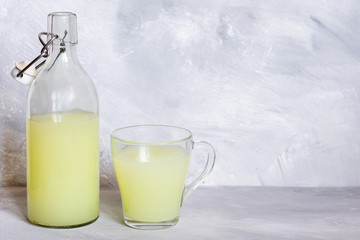Milk serum. Whey from homemade cottage cheese in a glass mug.