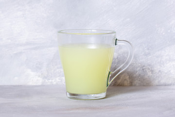 Milk serum. Whey from homemade cottage cheese in a glass mug.