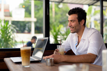 Fototapeta na wymiar Portrait of happy Turkish man smiling at the coffee shop