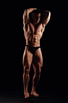 Strong men posing and showing muscles. Great shape before championship. Perfect for sport nutrition promo. Athlete and bodybuilder. Close-ups. Black background.