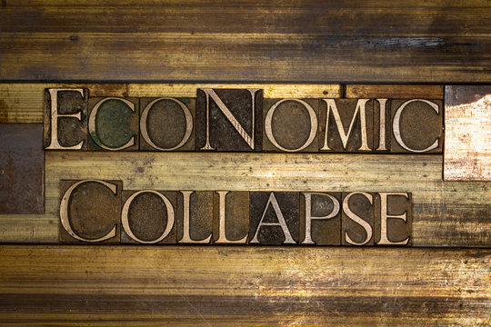 Photo of real authentic typeset letters forming Economic Collapse text on vintage textured grunge copper background