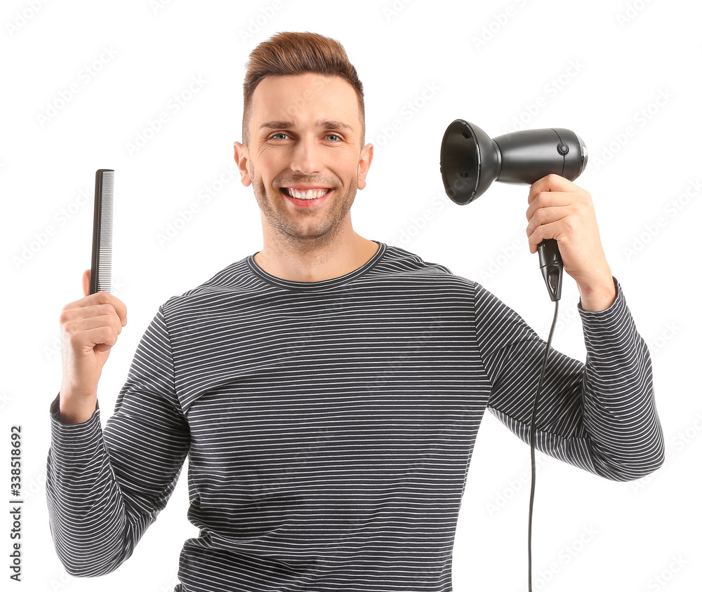 Poster handsome young man with comb and blow dryer on white background