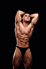 Strong men posing and showing muscles. Great shape before championship. Perfect for sport nutrition promo. Athlete and bodybuilder. Close-ups. Black background.