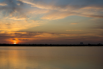 Obraz na płótnie Canvas sunrise over lake, launch pad in background, cape canaveral
