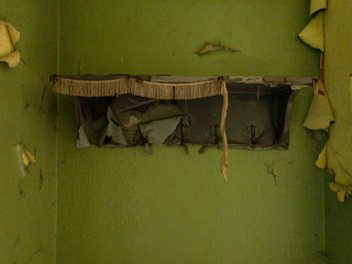 A derelict shelf on the ruined walls of an abandoned building