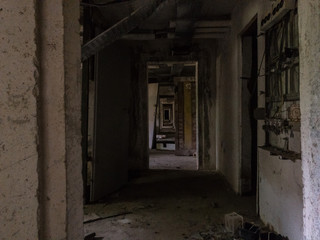 A dark and decaying corridor in an abandoned building